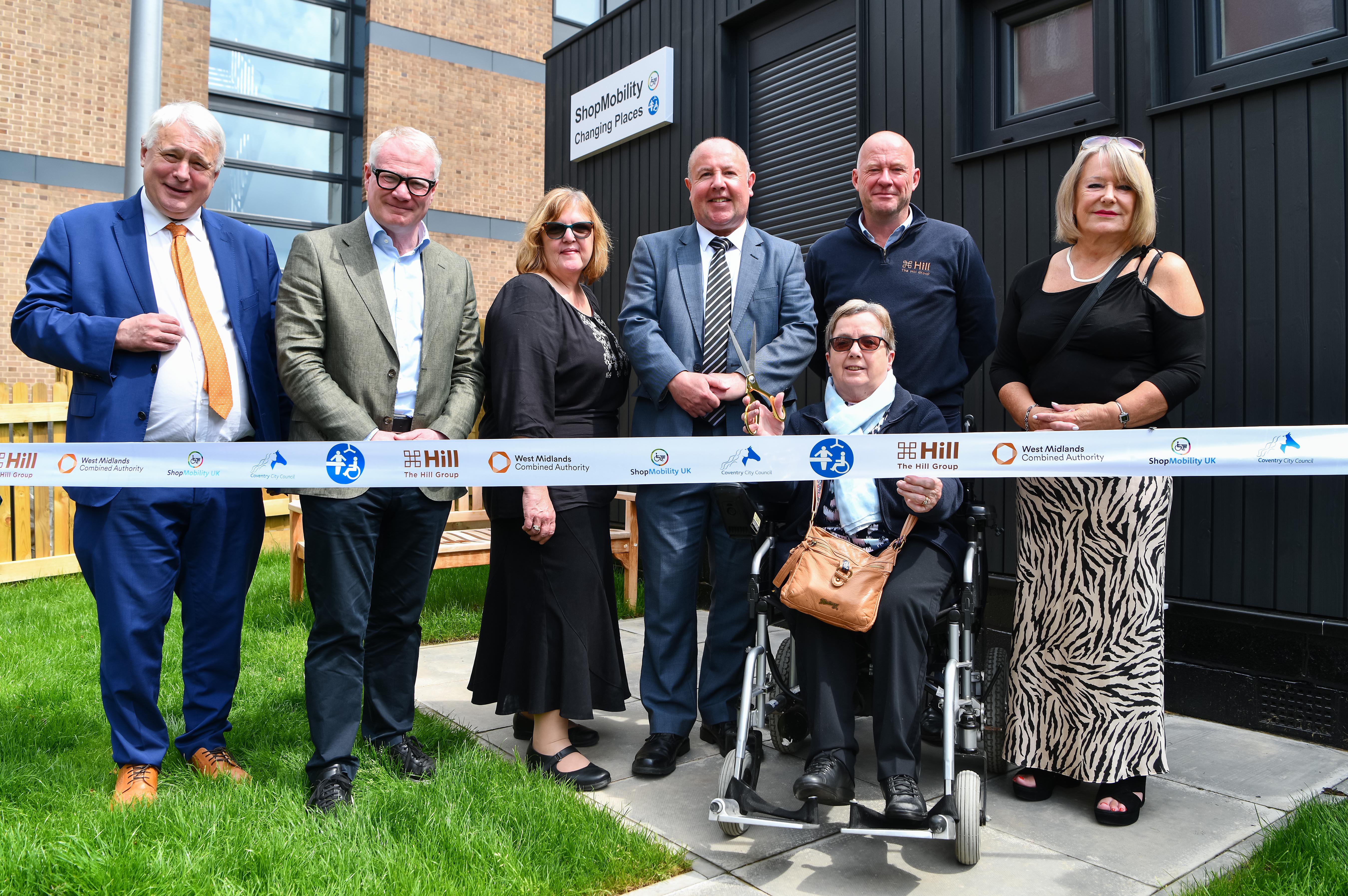 Cllr George Duggins; Richard Parker, Mayor of the West Midlands; manager of ShopMobility Jo Sanders; Cllr Jim O'Boyle; Andy Fancy, managing director of The Hill Group; and Cllr Patricia Hetherton with Barbara Gibbs, a regular user of ShopMobility, at the official opening of the new centre as part of the WMCA-funded City Centre South regeneration.