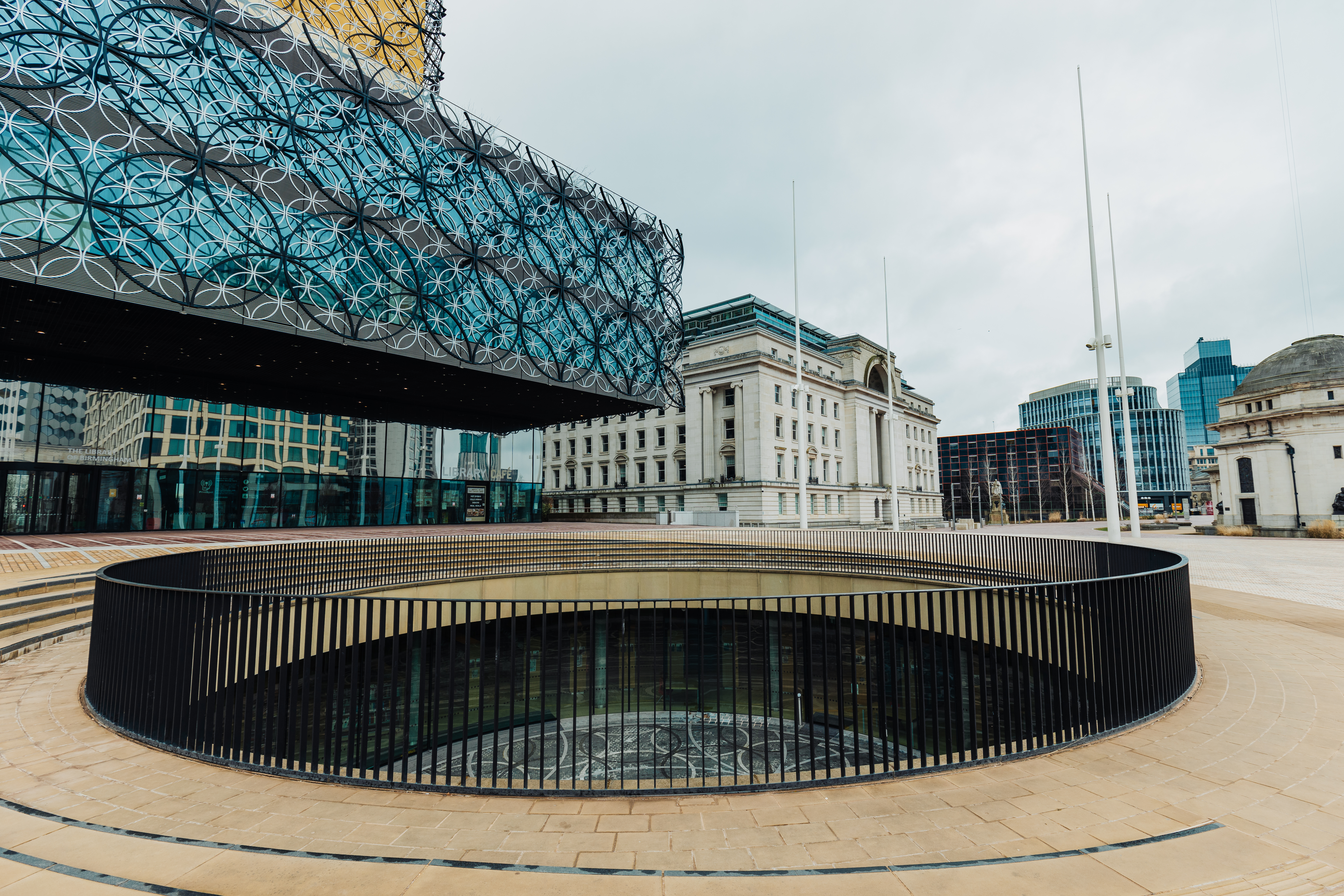 Image shows a public square with the Library of Birmingham to the left and Baskerville House in the distance