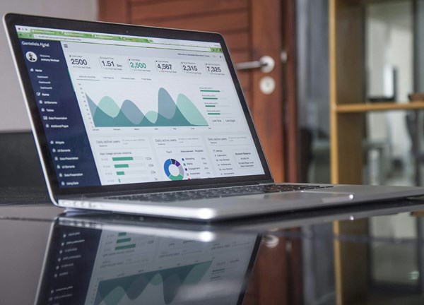 Laptop computer showing a dashboard of charts