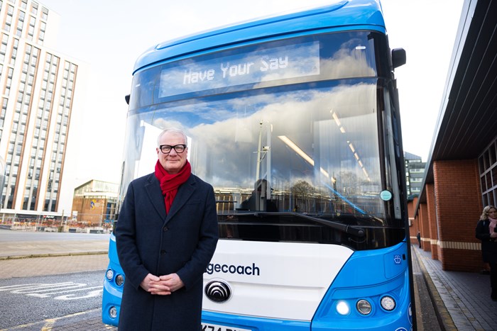 Mayor Richard Parker standing in front of blue single-deck bus with sign on the front saying 'Have Your Say'