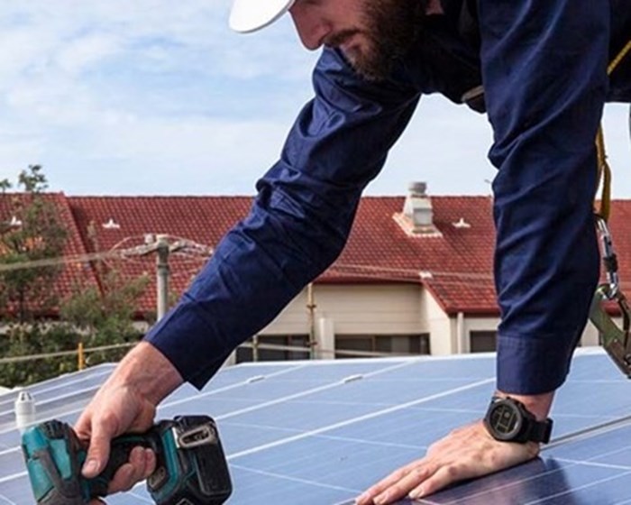 Man working on solar panels